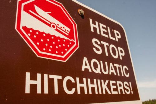 Road sign that says help stop aquatic hitchhikers!